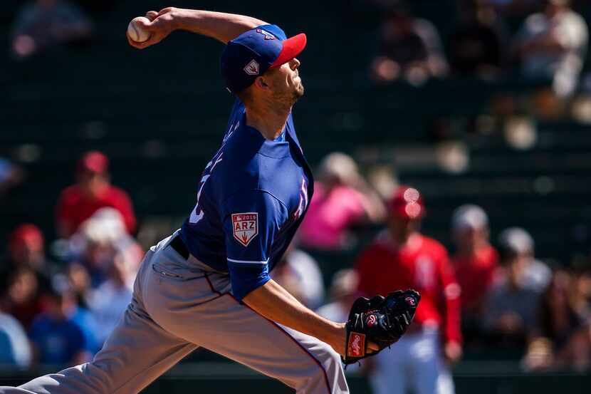 Texas Rangers pitcher Drew Smyly delivers during the first inning of a spring training...