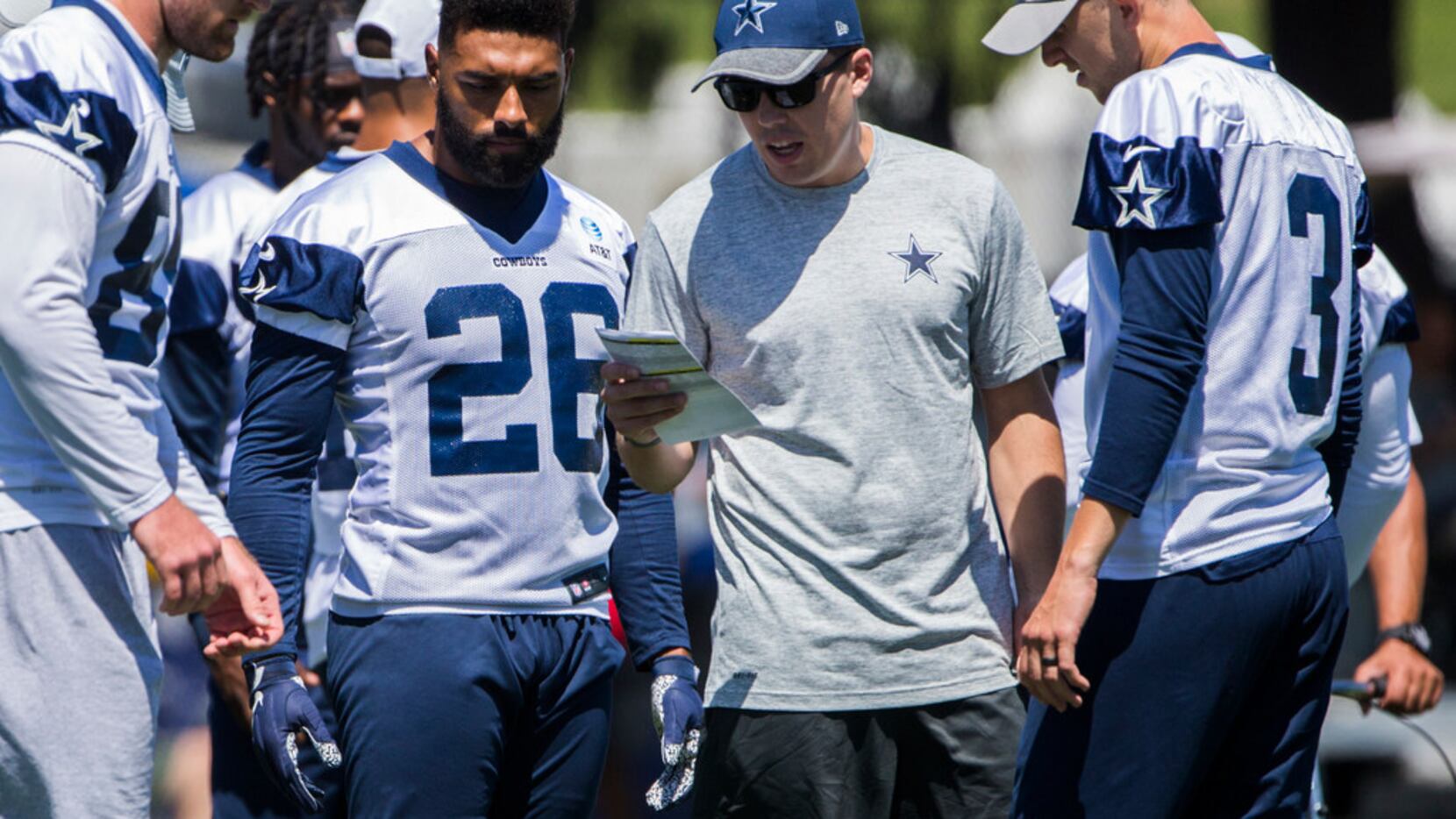 Dallas Cowboys Offensive Coordinator Kellen Moore (second from right) calls a play during a...