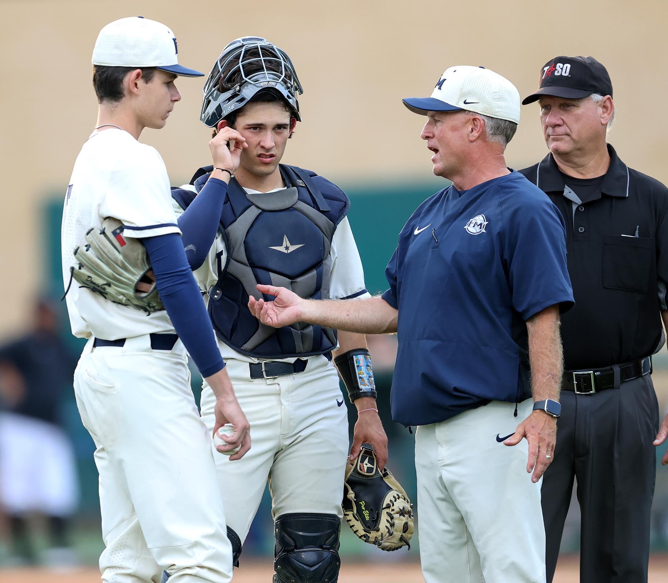 Flower Mound head coach Danny Wallace chats with starting pitcher Zach James, (left) and...
