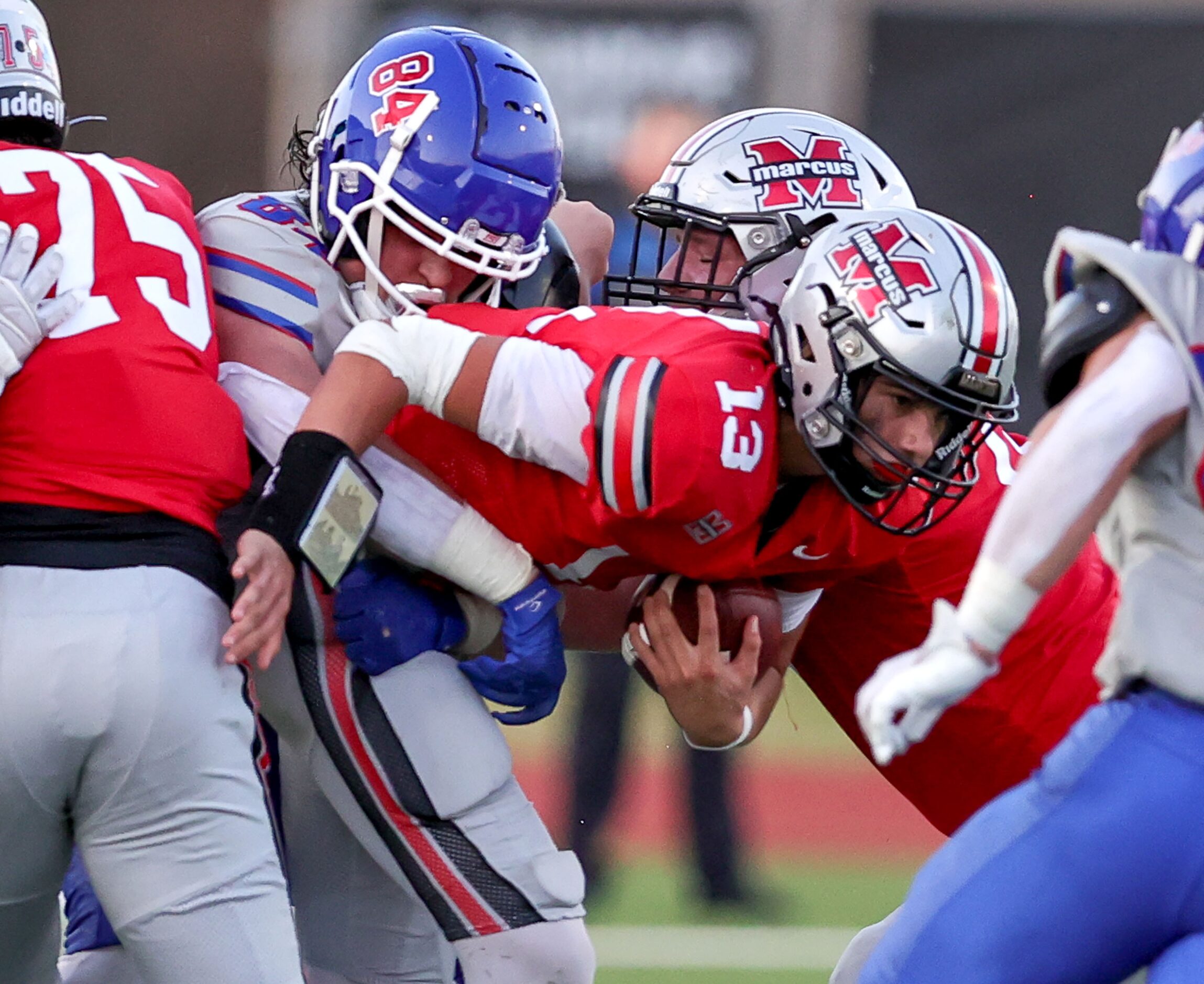 Flower Mound Marcus quarterback Colton Nussmeier (13) gets sacked by Richardson Pearce...