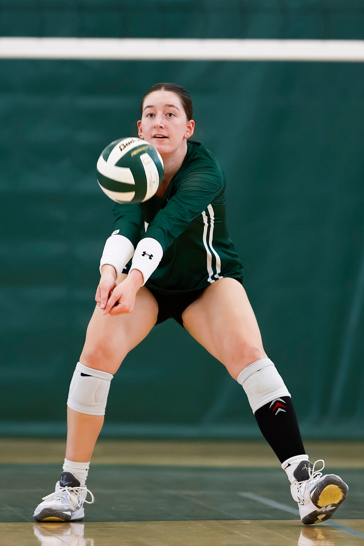 Hockaday junior middle blocker Olivia Wayne digs the ball during a high school volleyball...