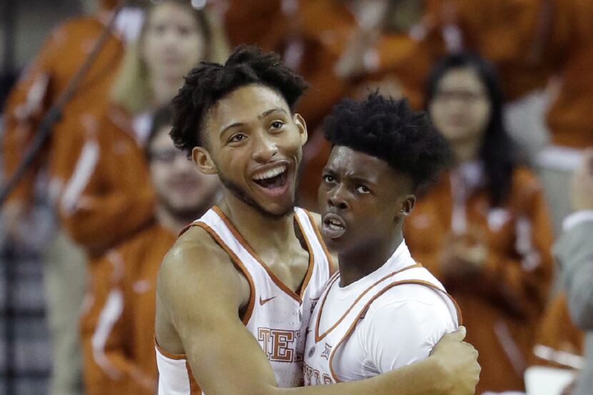 Texas center James Banks (4) celebrates a sore by guard Andrew Jones, right, during the...