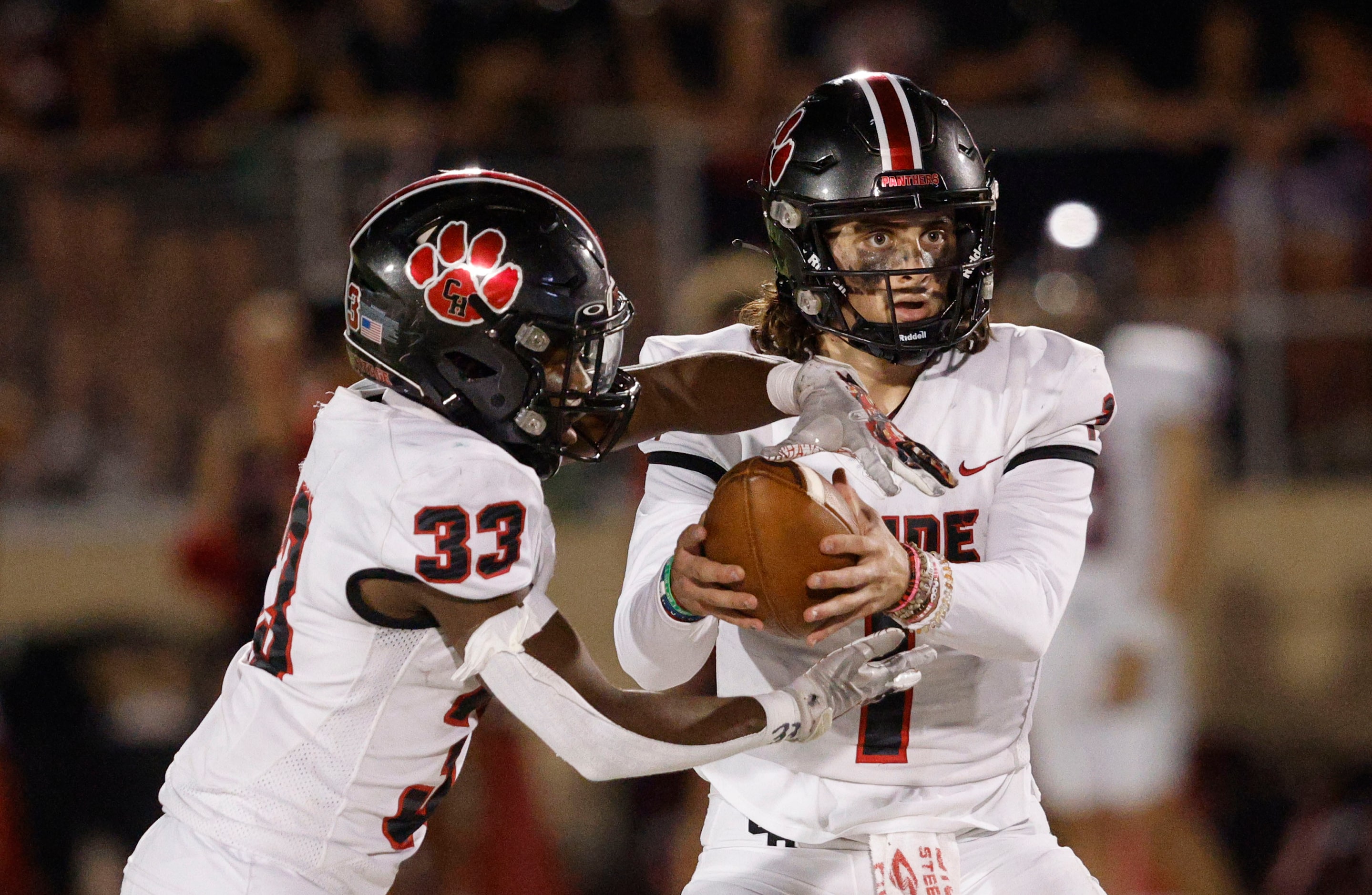 Colleyville Heritage's Luke Ullrich (1) hands off to Colleyville Heritage's Colin Bennett...