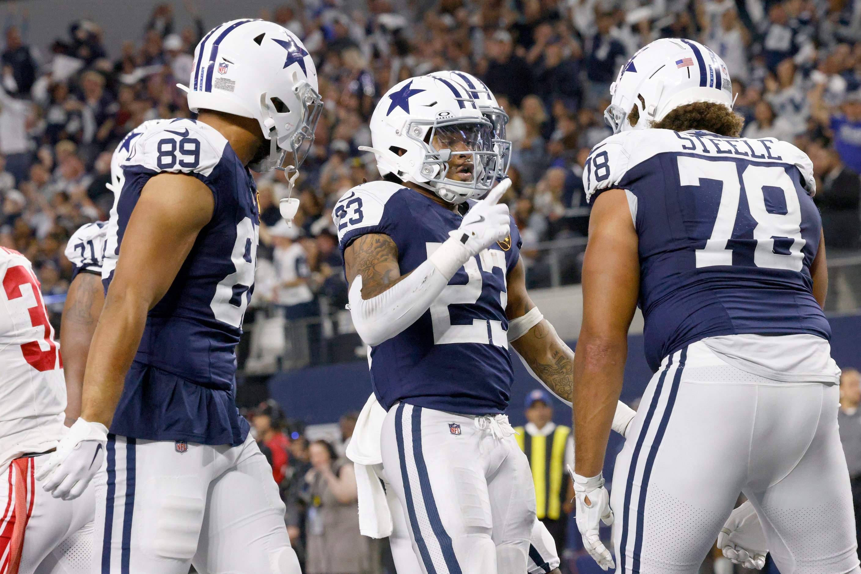 Dallas Cowboys running back Rico Dowdle (23) celebrates with his teammates tight end Brevyn...