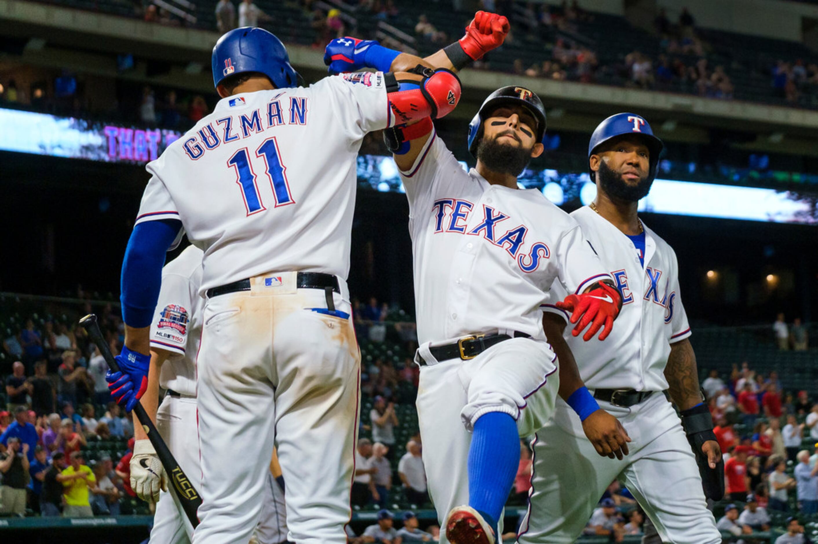 Texas Rangers second baseman Rougned Odor celebrates with first baseman Ronald Guzman after...