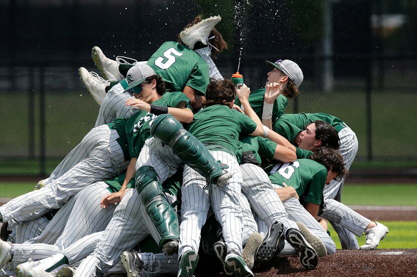 Team mates pile onto Reedy High School pitcher Jack Jorgenson (10) on the mound after he...