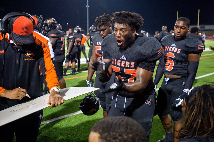 Lancaster senior defensive lineman Desonio Powell (57) gives an impassioned speech to his...