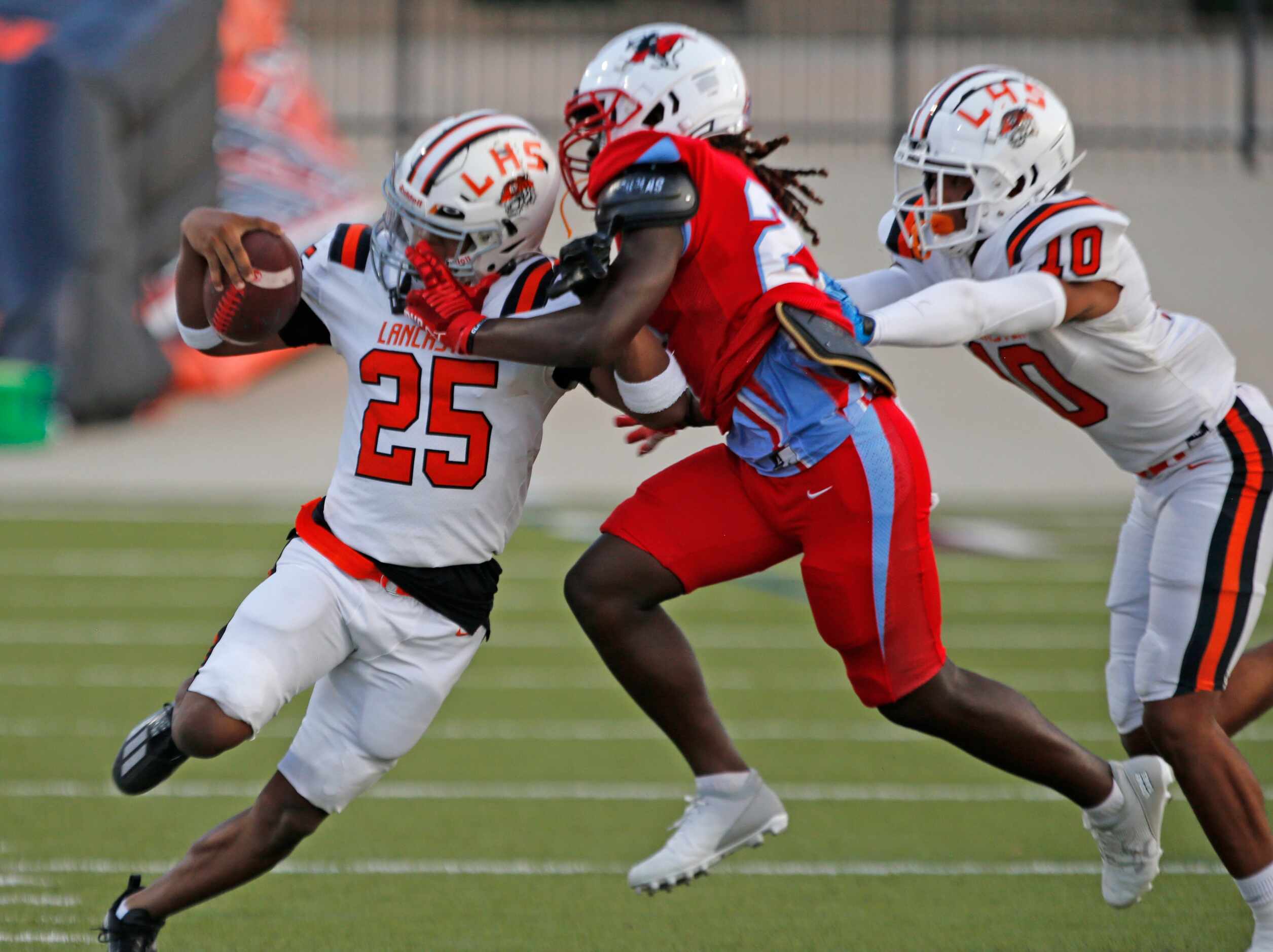 Lancaster High’s Nathan Keeton (25) is shoved out of bounds by Skyline High defender...