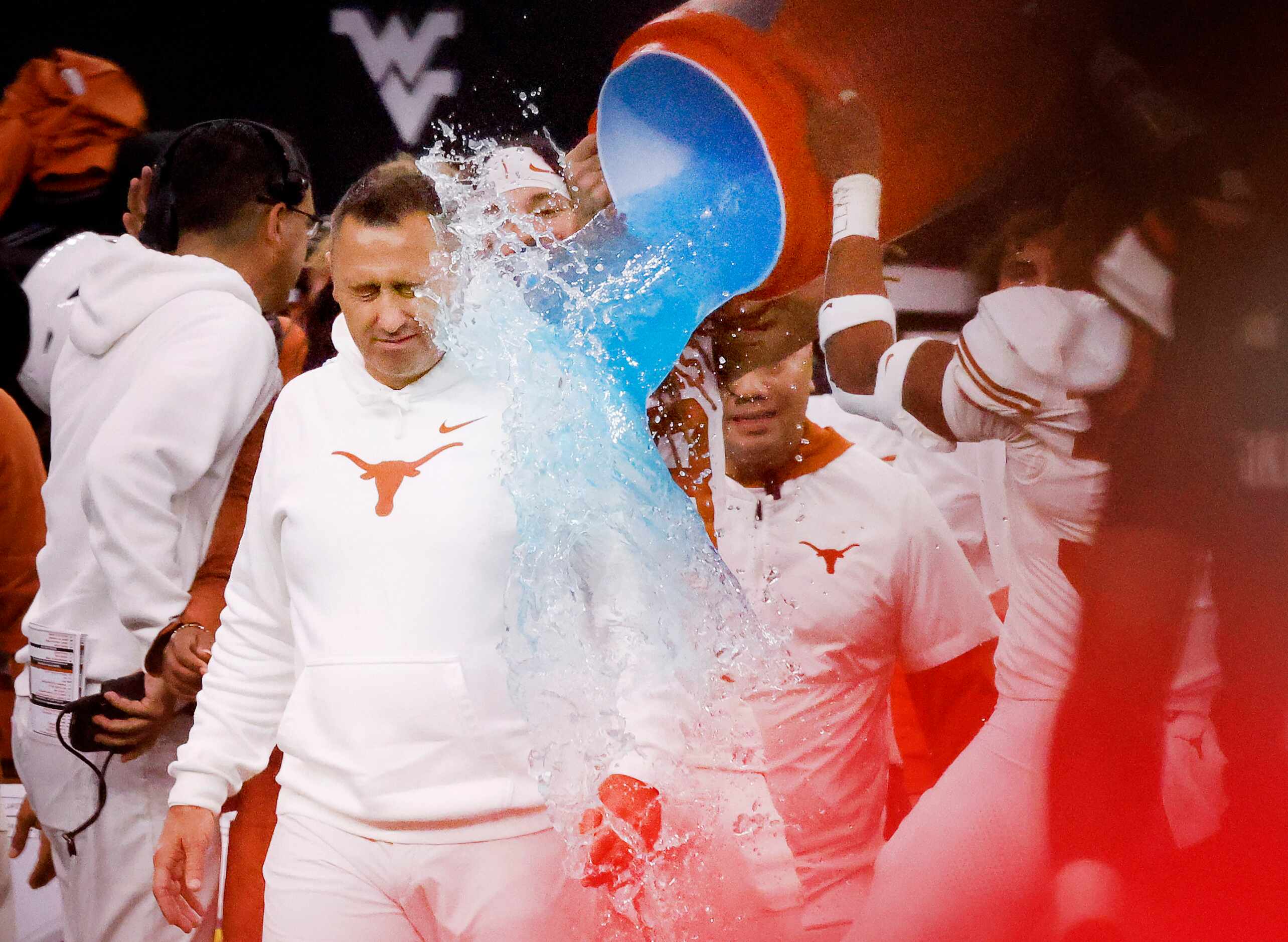 Texas Longhorns head coach Steve Sarkisian is doused with sports drink ass time expires on...