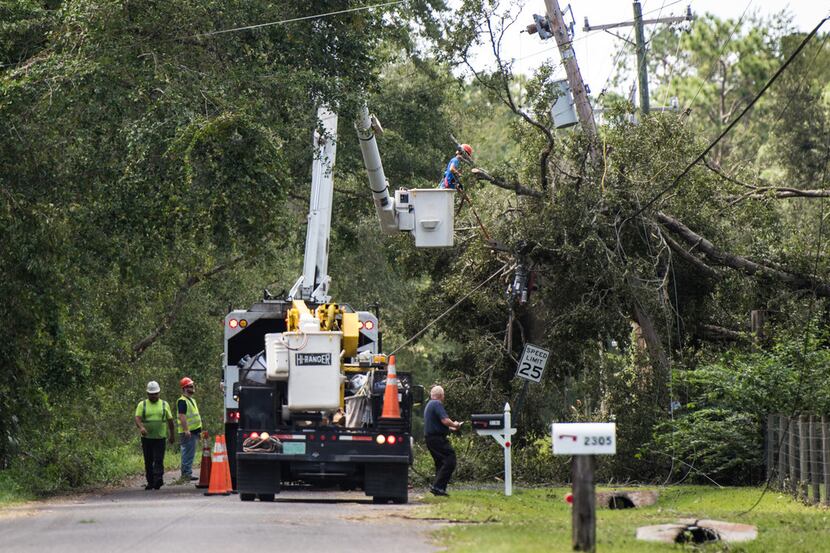 A utility crew repairs lines damaged by Hurricane Irma Sept. 12 in Hastings, Fla. The storm...
