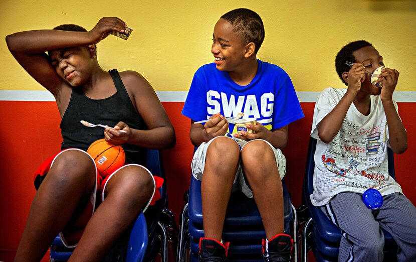 (From left) Broderick Brown winces with brain freeze while Brandon Little-Tullos laughs as...