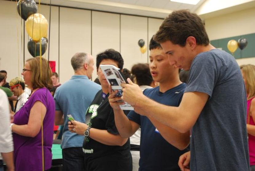 
Graduating seniors Harry Bui, left, and Garrett Smith look at an old yearbook from their...