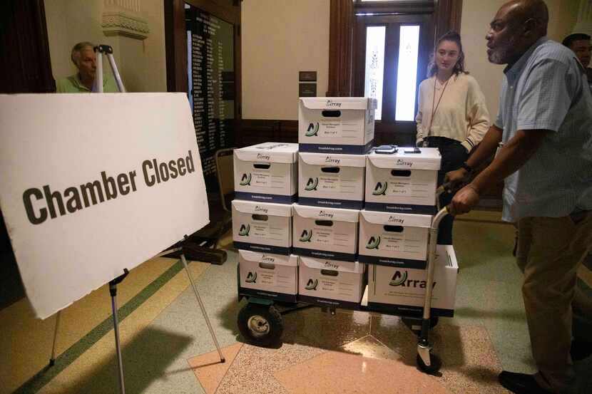 Boxes with exhibit items were wheeled into the Senate chamber after the Senate was adjourned...