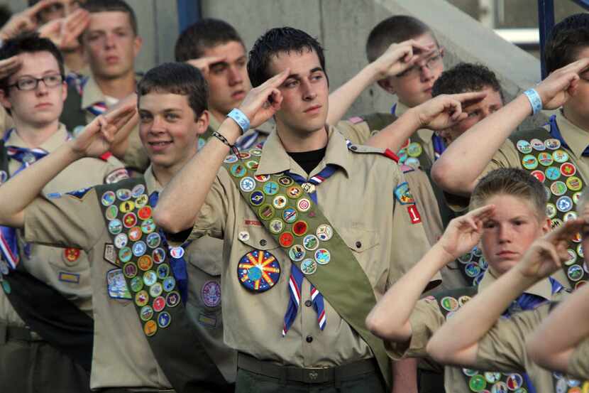 In this July 3, 2010, photo, Boy Scouts salute during the Stadium of Fire in Provo, Utah....