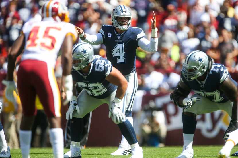 Dallas Cowboys quarterback Dak Prescott (4) makes an adjustment during an NFL game at FedEx...