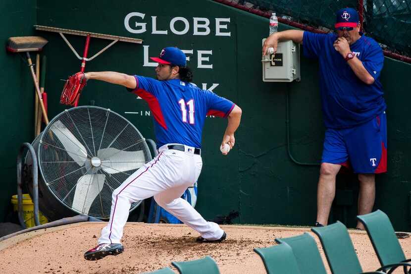 Texas Rangers starting pitcher Yu Darvish throws in the bullpen during the team workout at...