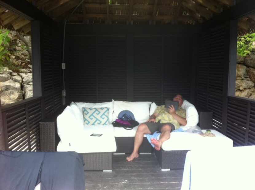  DMN editorial writer Michael Hashimoto loafing in a beachfront cabana the day before, in...