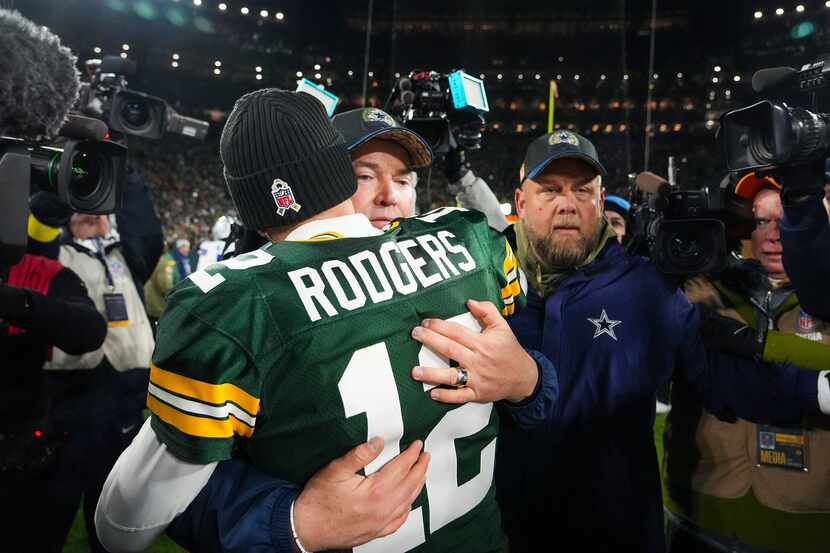Dallas Cowboys head coach Mike McCarthy hugs Green Bay Packers quarterback Aaron Rodgers...