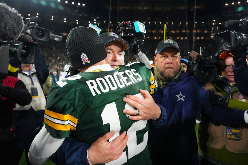 Dallas Cowboys head coach Mike McCarthy hugs Green Bay Packers quarterback Aaron Rodgers...