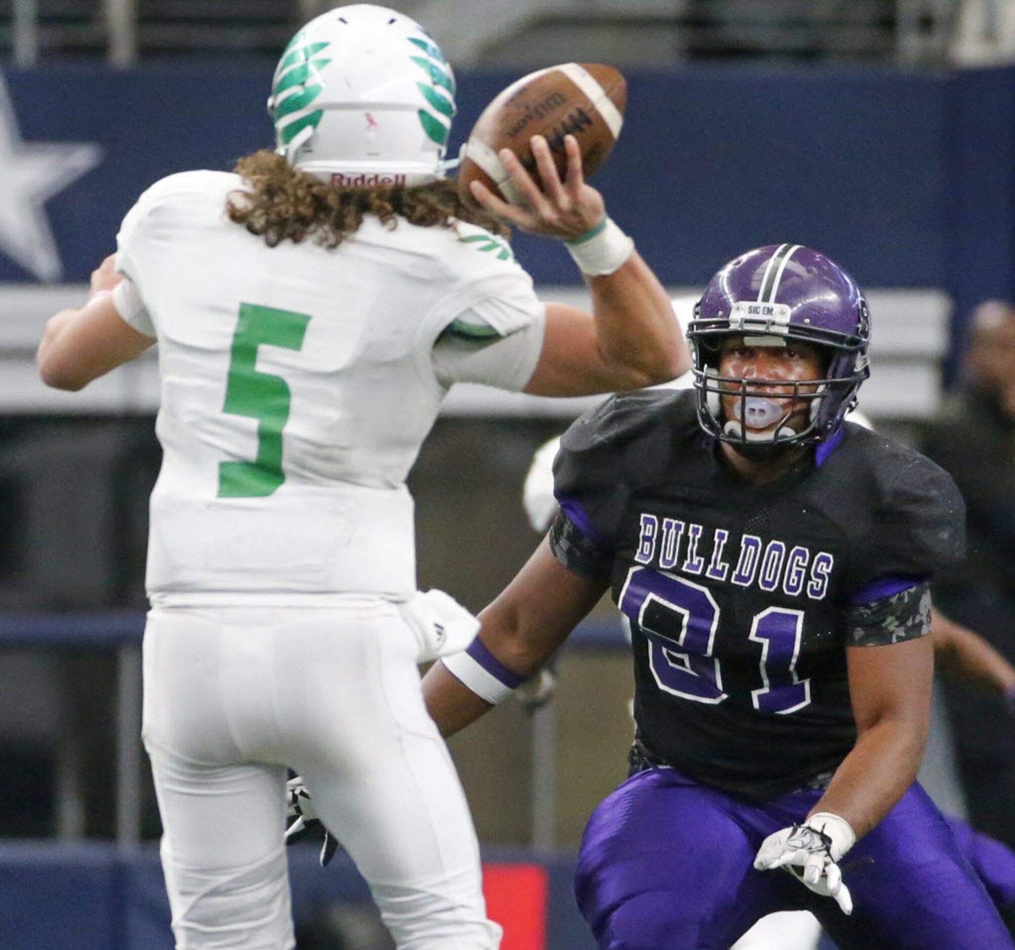 Lake Dallas quarterback Dagan Haehn (5) gets a pass away under pressure from Everman's...