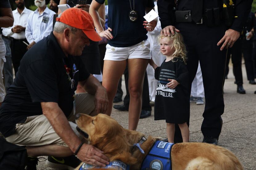 Senior Cpl. Daniel Sullivan (no face) with his daughter Sofia, 2 and wife Brandi, watch as...