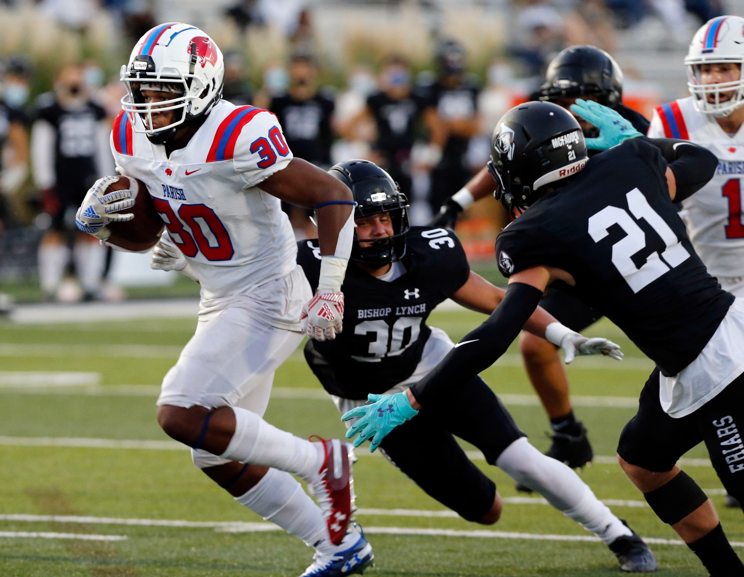 Parish Episcopal’s Andrew Paul (30) runs a a touchdown, as bishop Lynch defenders Ben Haynes...