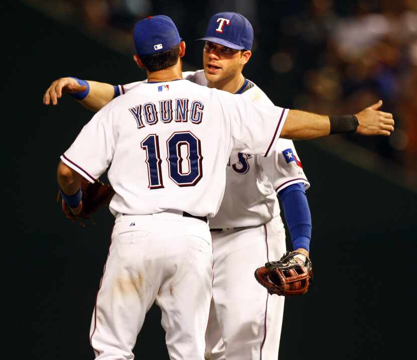 Texas Rangers third baseman Michael Young (10) and teammate Chris Davis (19) celebrate after...