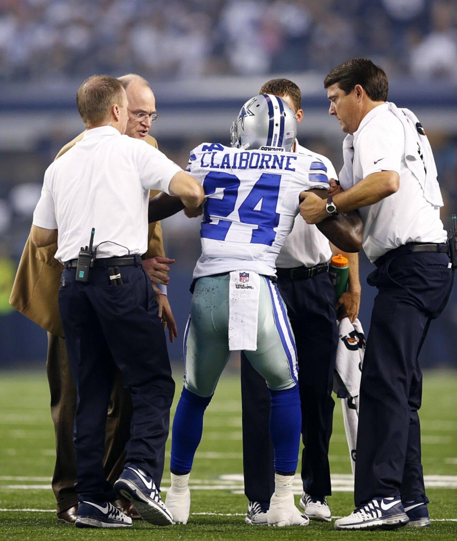 The medical staff helps Dallas Cowboys cornerback Morris Claiborne (24) to his feet after...