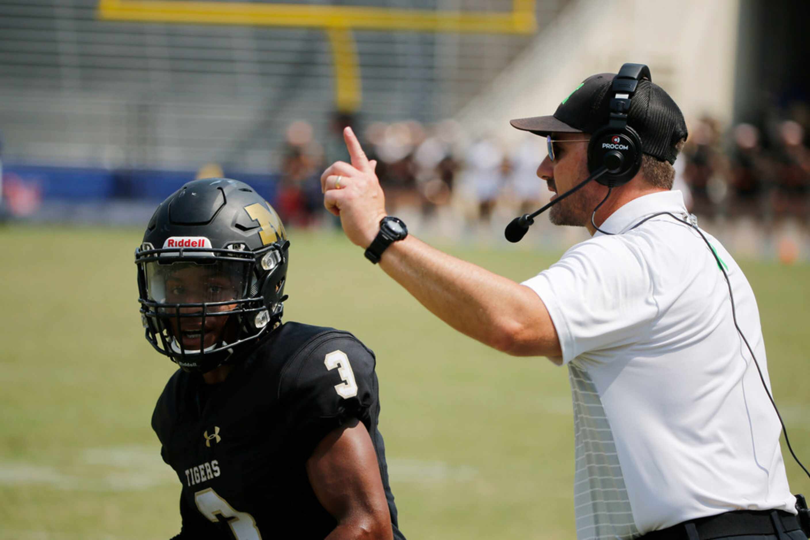 Martin interim coach Greg George directs Dameon Gomes (3) during the first half of their...