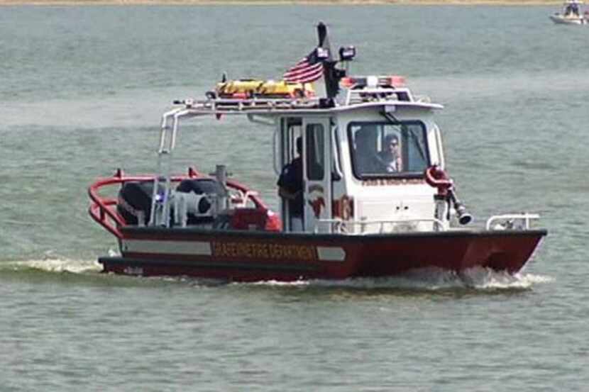A Grapevine Fire Department water crew searches for a man who fell off a boat and never...
