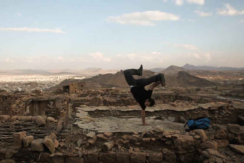 A dancer breaks amid ruins in Yemen in a scene from "Shake the Dust," a documentary about...