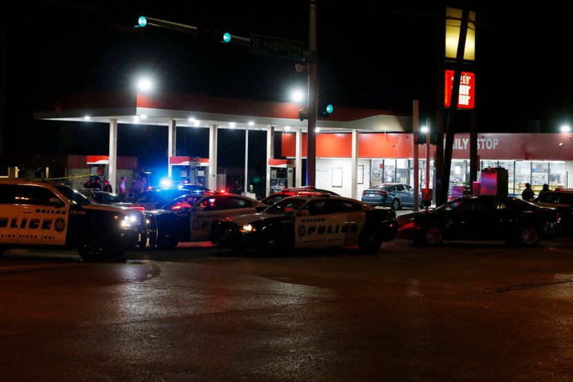 Dallas Police investigate the scene of a shooting where a 13-year-old boy died after being...