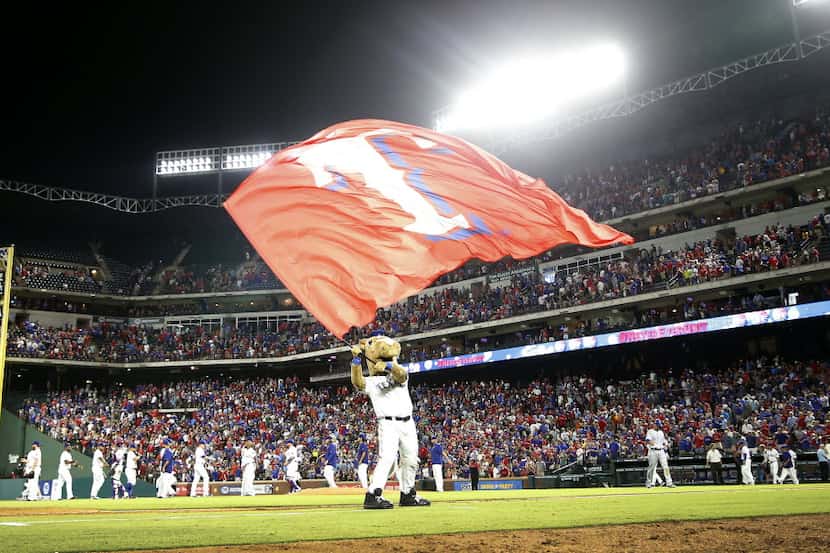 Texas Rangers mascot Rangers Captain waves a team flag after the Rangers beat Kansas City...