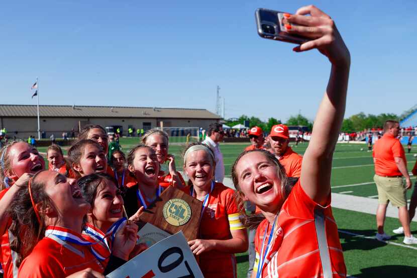Celina midfielder Mia Norman (10) takes a selfie with her teammates after winning the Class...