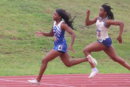 Fort Worth Southwest Christian's Aliyah Johnson (left) takes the lead in the 5A girls 200...