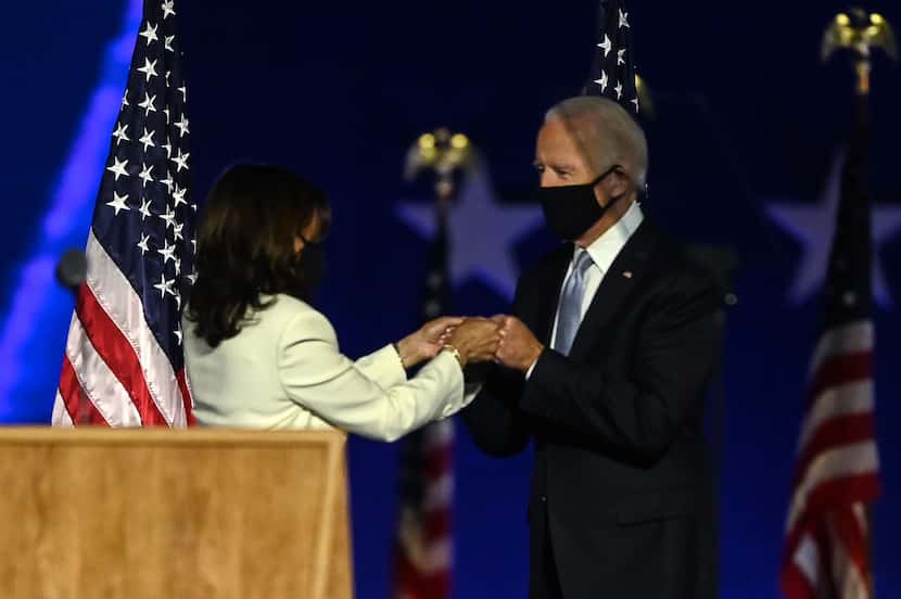 US President-elect Joe Biden and Vice President-elect Kamala Harris bump fists as they...