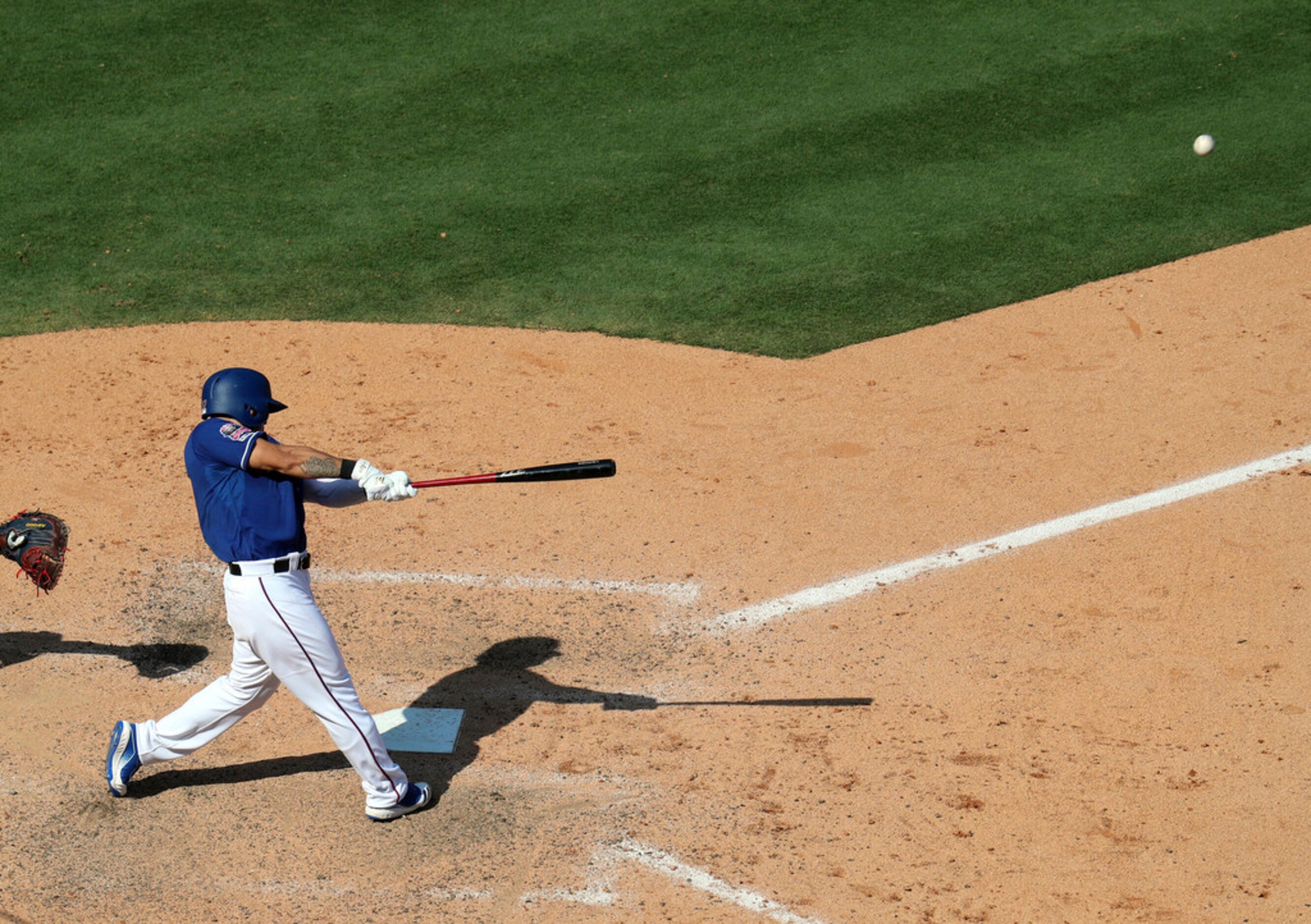 Texas Rangers left fielder Shin-Soo Choo hits a solo home run in the seventh inning of a...