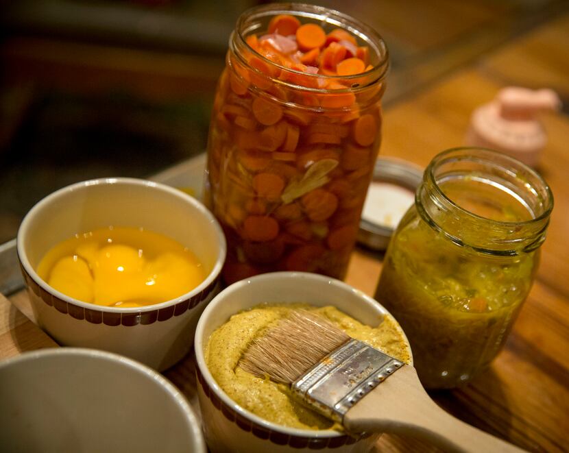 (Clockwise from left) An egg wash, pickled vegetables, a relish and mustard used by...