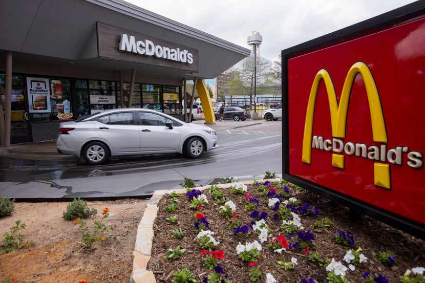 Drivers go through the drive-thru at the downtown Dallas McDonald’s on Friday, March 29,...