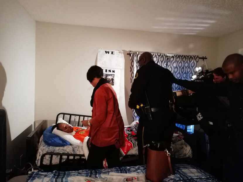 Police Chief U. Renee Hall, in red coat, visits Ayodeji Adekilekun, as he was named Dallas...