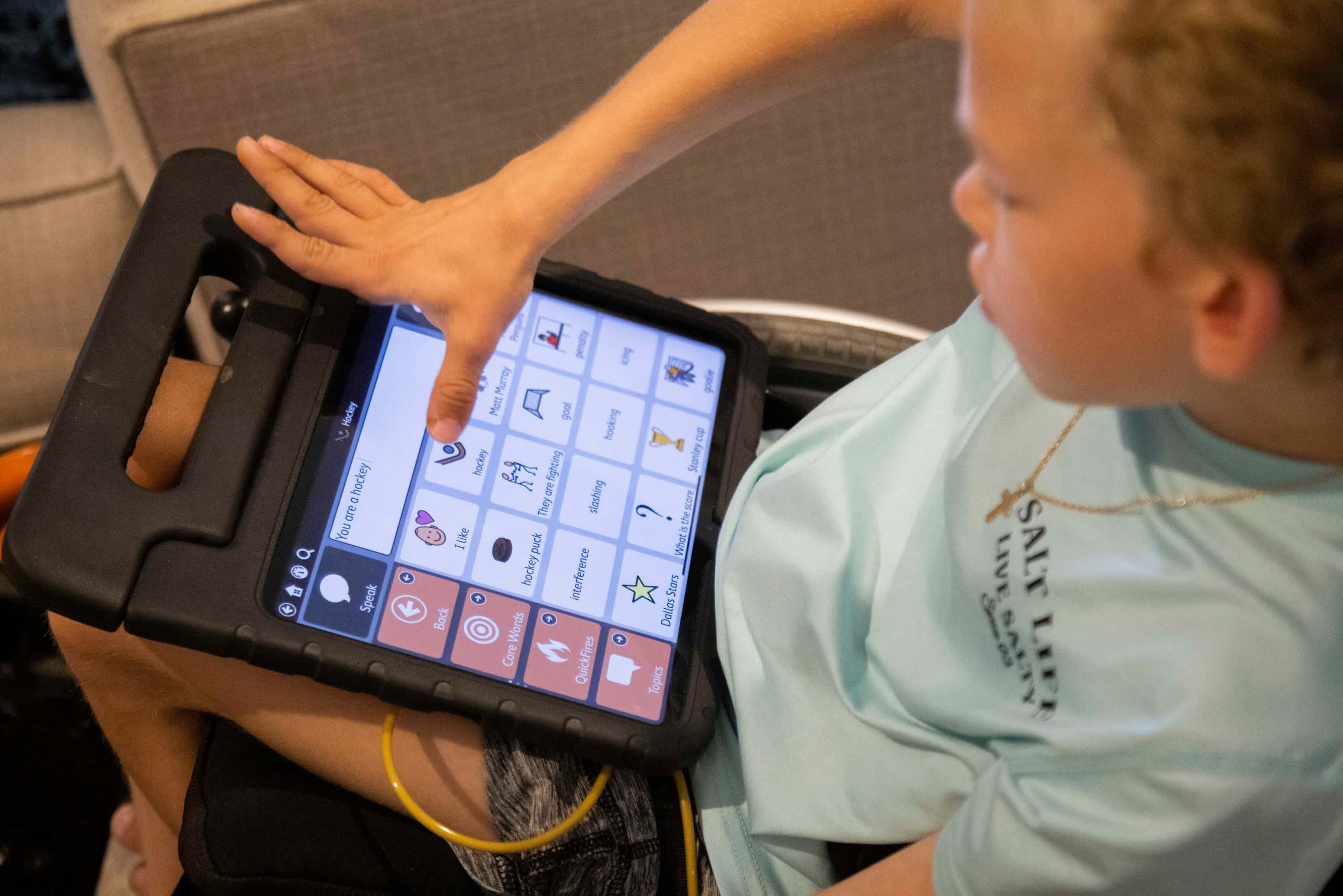Will Woleben, 11, uses his iPad to write the sentence “You are a hockey player” during his...