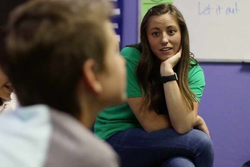 A counselor listens to a child's story during a session of the Five Star Kids program at the...