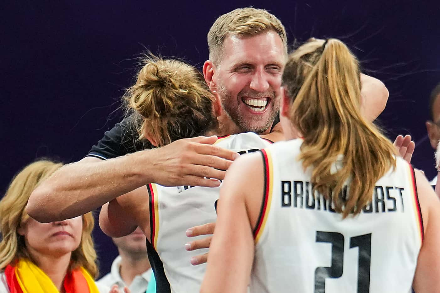 Dallas Mavericks great Dirk Nowitzki hugs Germany’s Marie Reichert (6) as they celebrate a...