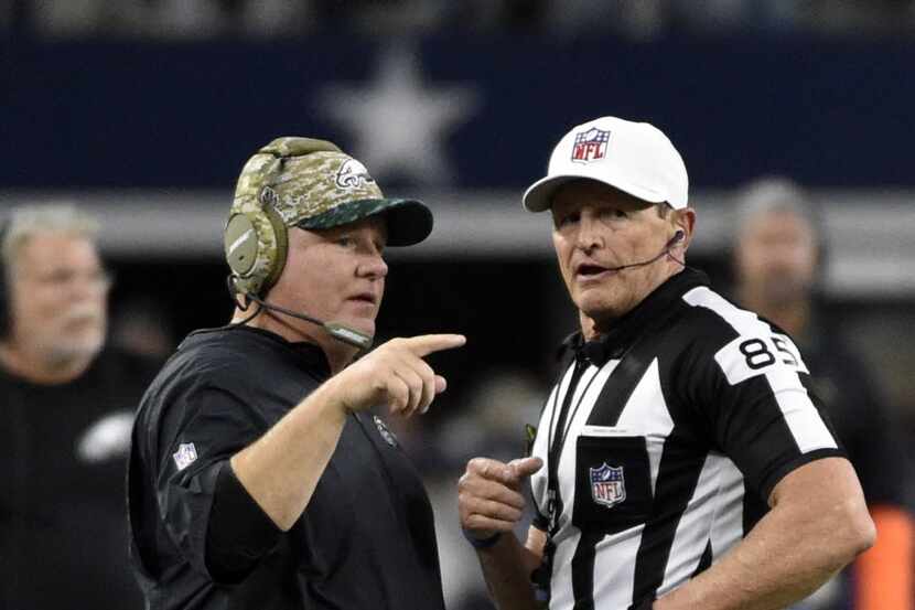 Philadelphia Eagles head coach Chip Kelly, left, talks with referee Ed Hochuli (85) in the...