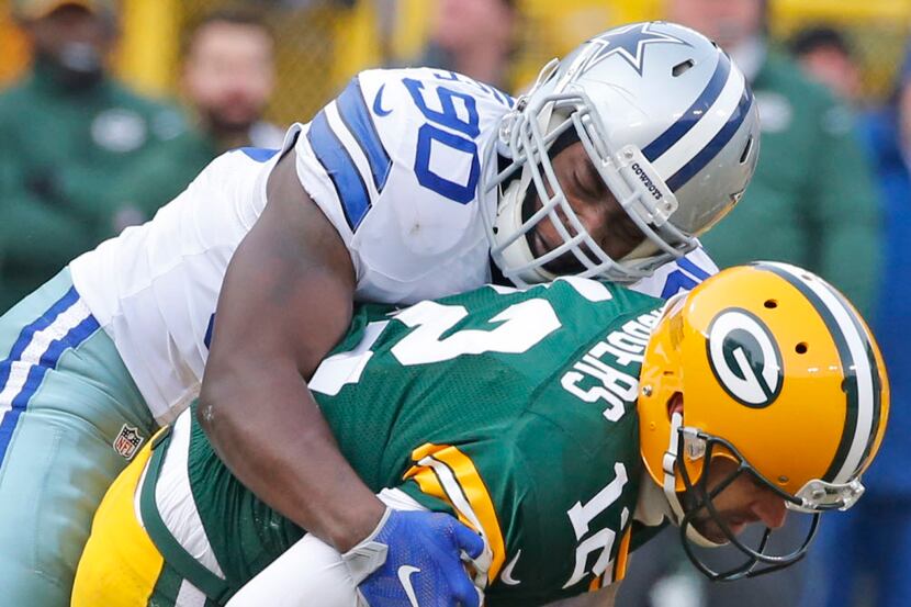 Dallas Cowboys defensive end DeMarcus Lawrence (90) sacks Green Bay Packers quarterback...