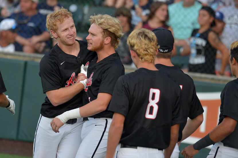 Argyle Eagles shortstop Brenden Dixon (5) celebrating with Argyle Eagles centerfielder...