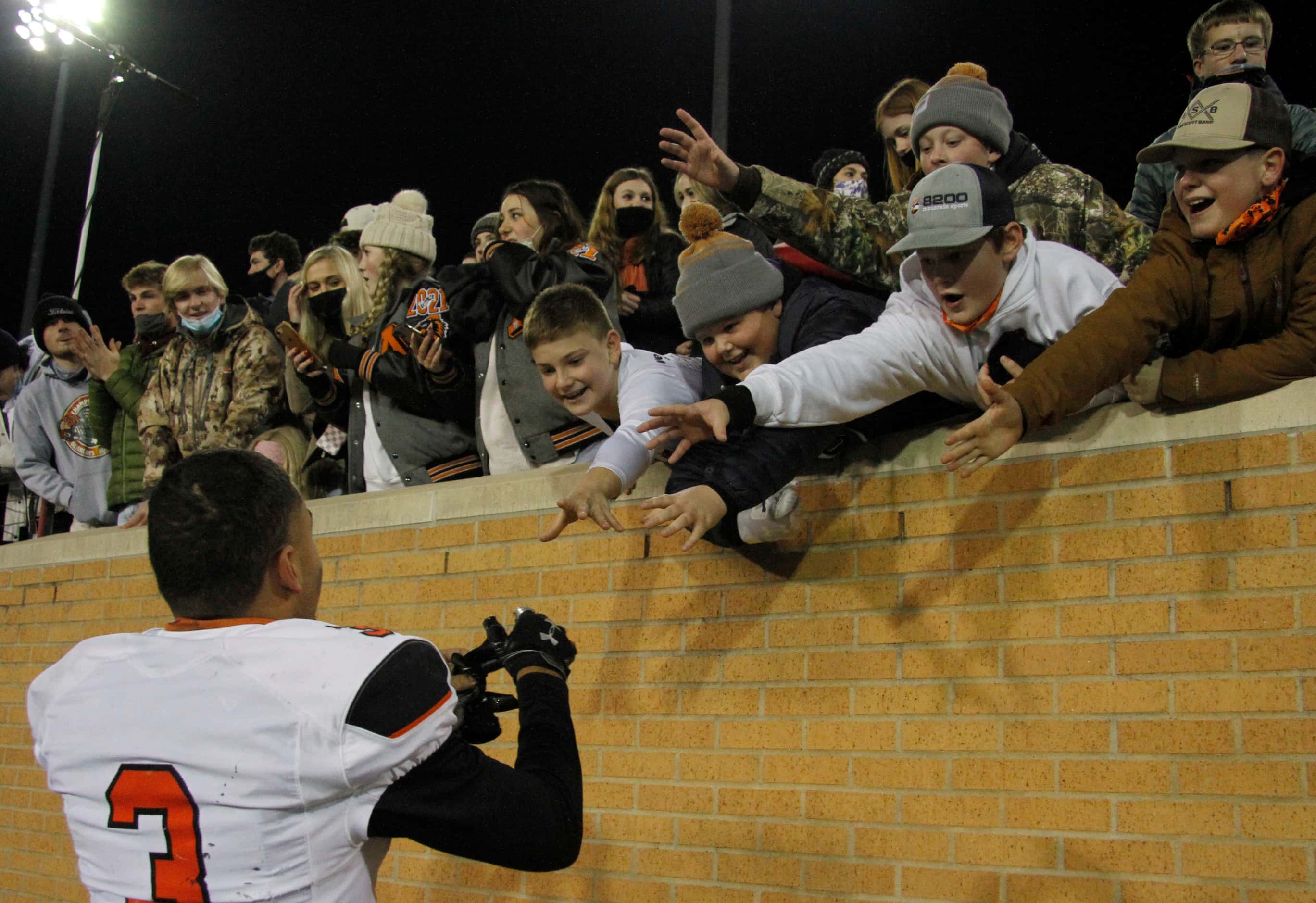 Aledo running back Jeremiah James (3) draws the attention of young Bearcats fans as they...
