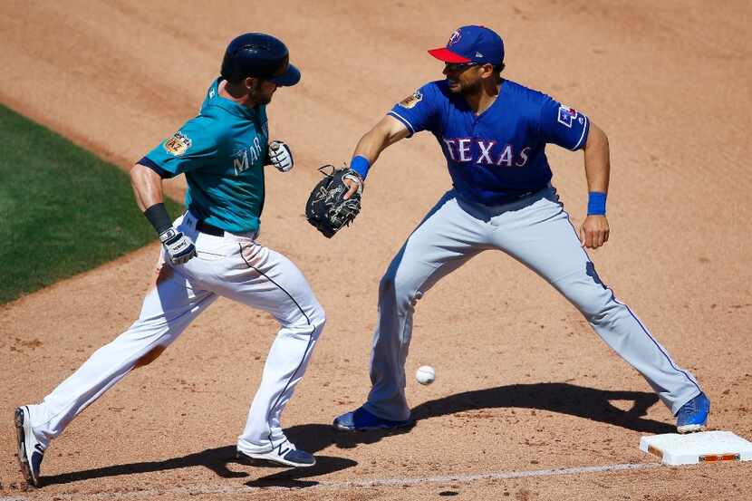 Texas Rangers' James Loney, right, is unable to make the catch on a wide throw by Drew...