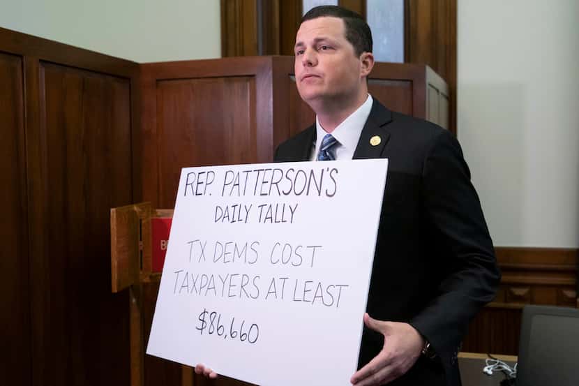 State Rep. Jared Patterson, R-Frisco, holds a sign in the Speaker's Committee Room detailing...
