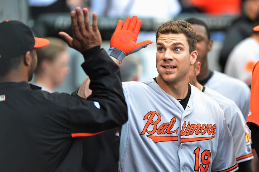 Baltimore Orioles' Chris Davis (19) celebrates with teammates in the dugout after hitting a...